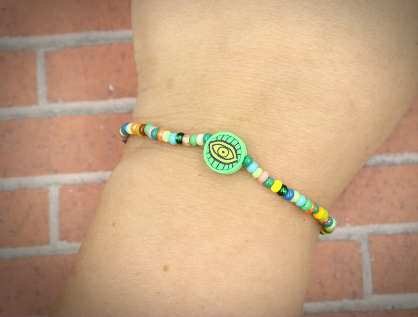 Green Eye of Envy Evil Eye Charm Colorful Seed Bead Stretch Bracelet by Monkey's Mojo