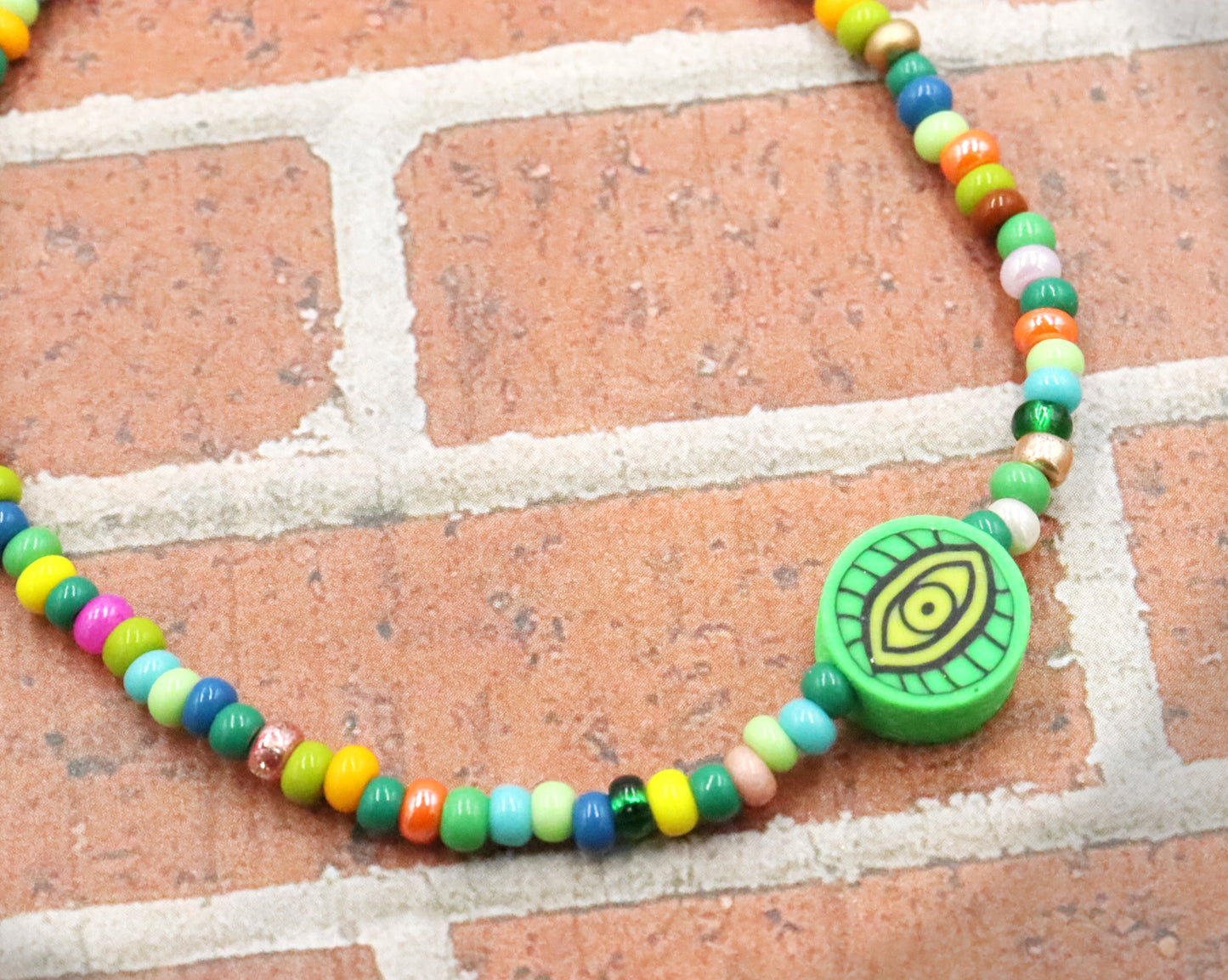 Green Eye of Envy Evil Eye Charm Colorful Seed Bead Stretch Bracelet by Monkey's Mojo
