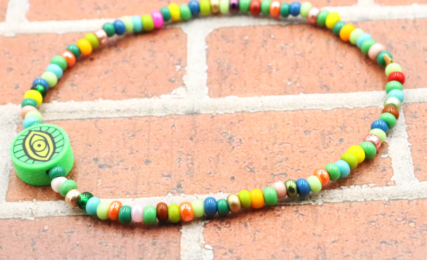 Green Eye of Envy Evil Eye Charm Colorful Seed Bead Stretch Bracelet by Monkey's Mojo