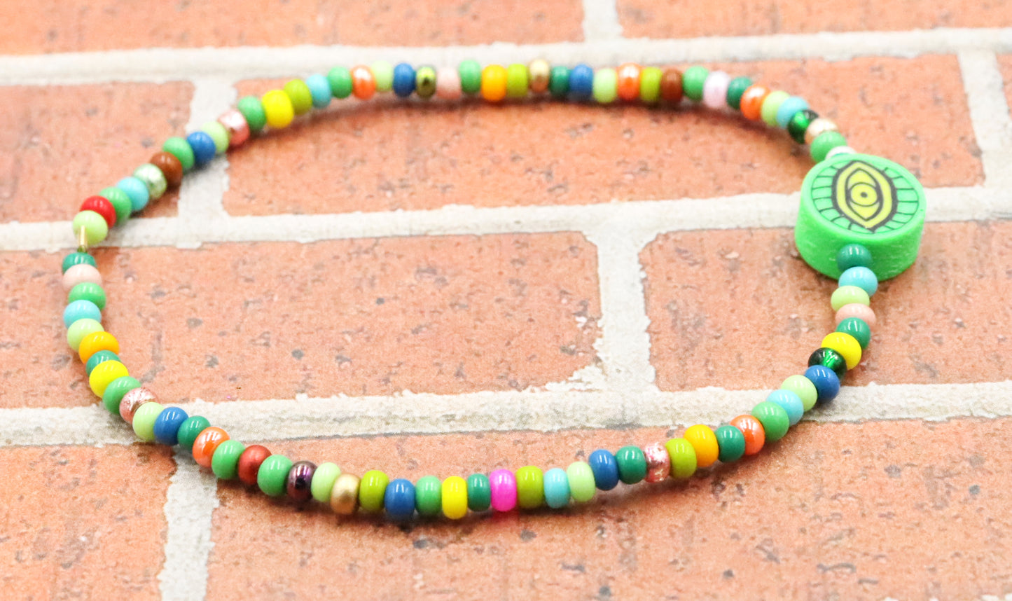 Green Eye of Envy Evil Eye Charm Colorful Seed Bead Stretch Bracelet by Monkey's Mojo