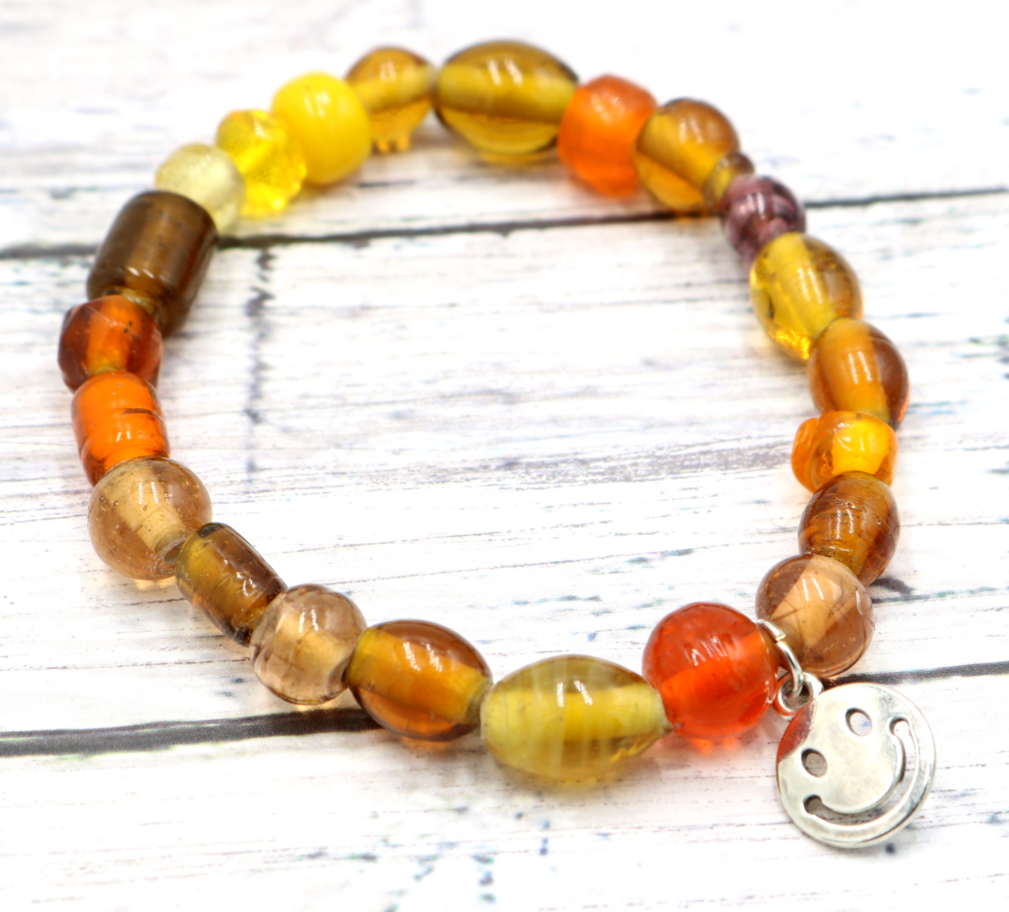 Yellow Hued Warm Artisan Glass Beads Bracelet with Silver Smile Face Charm by Monkey's Mojo