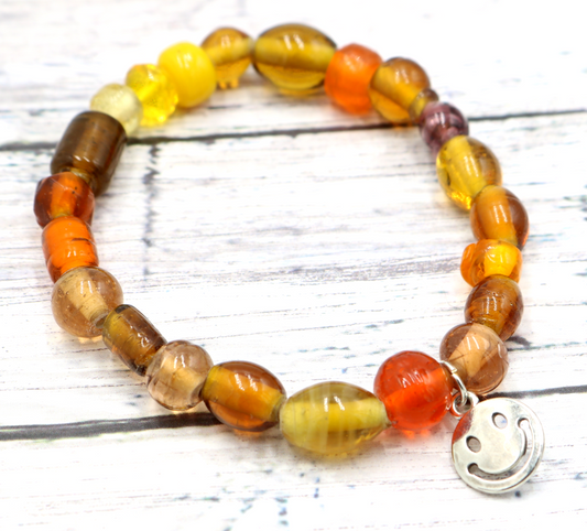 Yellow Hued Warm Artisan Glass Beads Bracelet with Silver Smile Face Charm by Monkey's Mojo