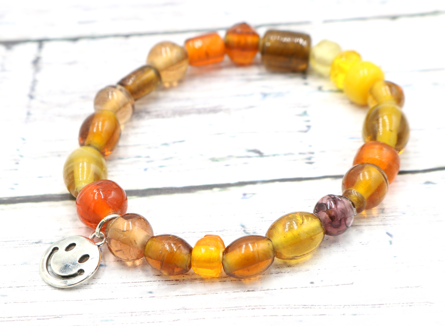 Yellow Hued Warm Artisan Glass Beads Bracelet with Silver Smile Face Charm by Monkey's Mojo